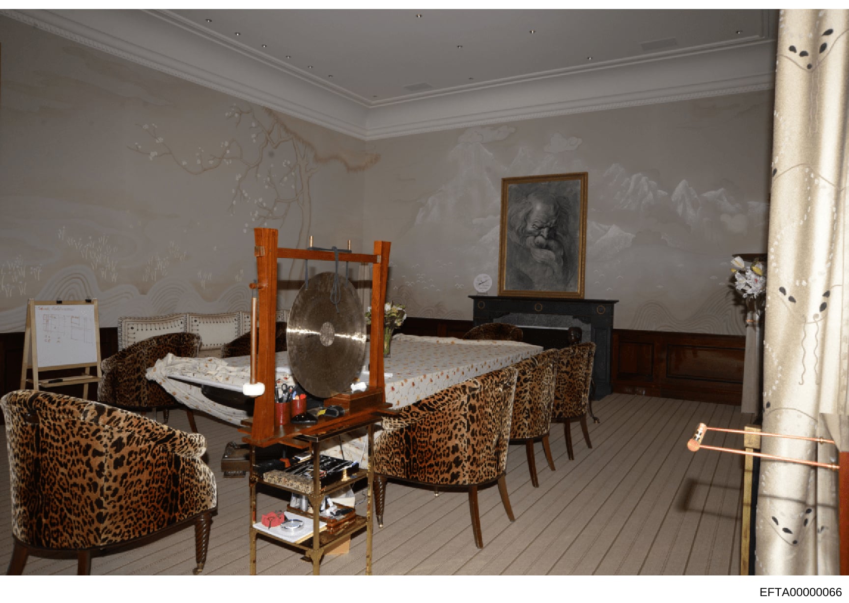 This is a photograph of an interior room featuring distinctive leopard-print upholstered furniture, an ornate wooden bed frame, and various decorative elements. The room appears to be a bedroom or living space with cream-colored walls, ornamental det