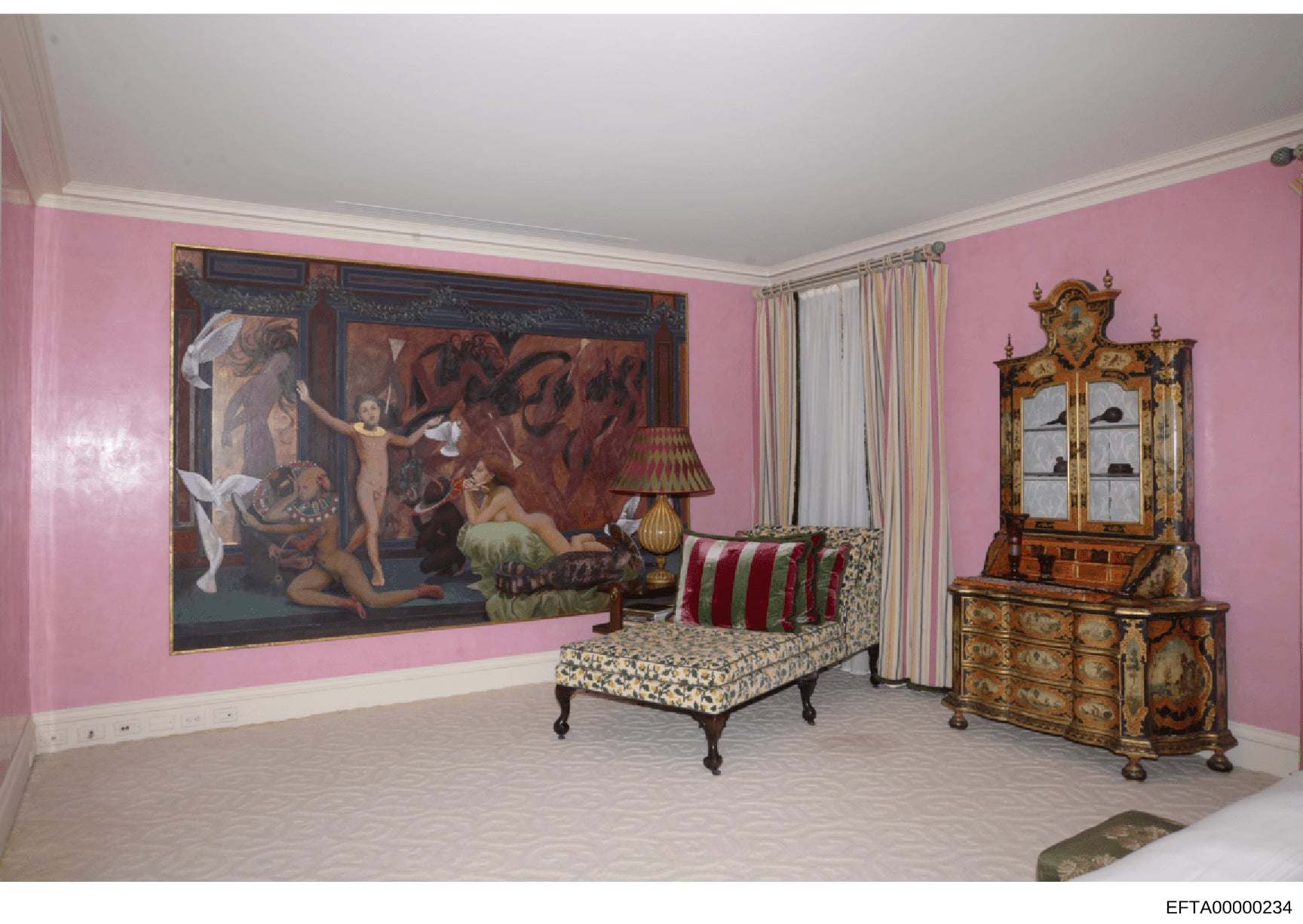 This is a photograph of an interior room with distinctive pink walls, featuring classical artwork, period furniture, and decorative objects. The room contains a large framed classical painting depicting mythological figures, antique wooden furniture