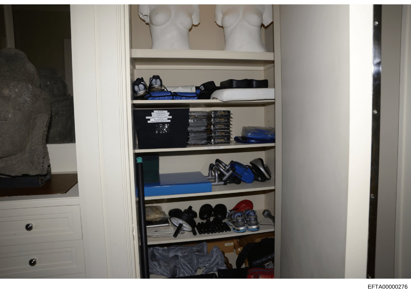 This is an evidence photograph showing the interior of a built-in closet containing various sports equipment, athletic shoes, clothing, and personal belongings. The image documents the contents and organization of what appears to be a residential clo