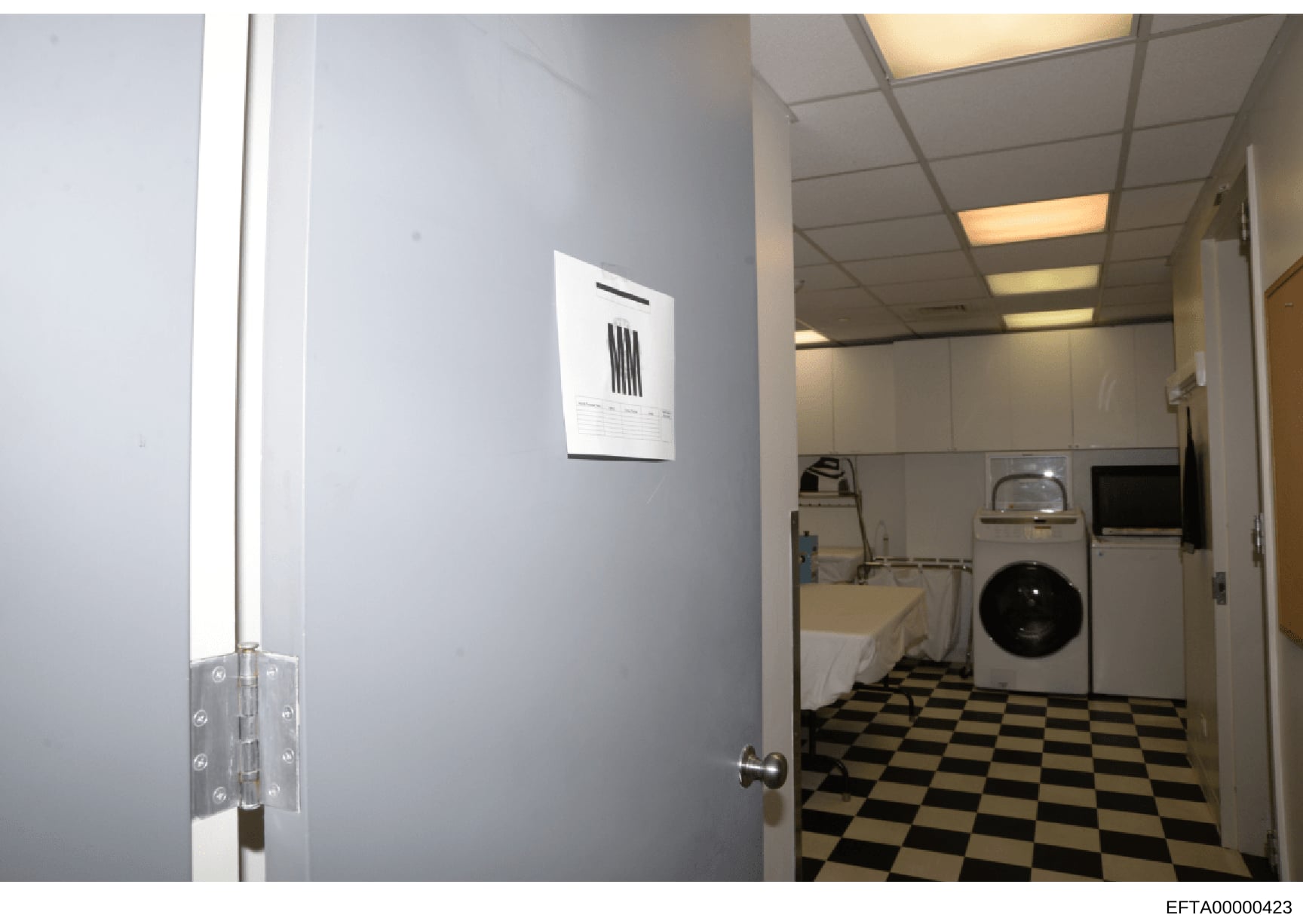 This photograph shows the interior of a laundry room, likely from one of Jeffrey Epstein's properties. The image depicts utility appliances including a washing machine, dryer, and utility sink, along with institutional-style fixtures and flooring. Th