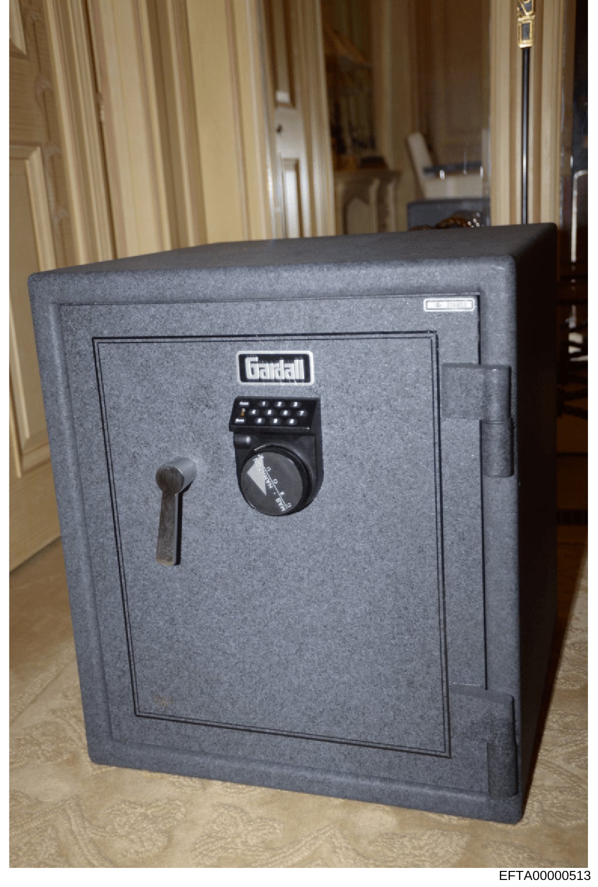 This is a photograph of a Gardall brand security safe discovered during the investigation of Jeffrey Epstein's property. The safe features a combination lock and manual key lock, indicating it was used to store valuables or documents. The image shows
