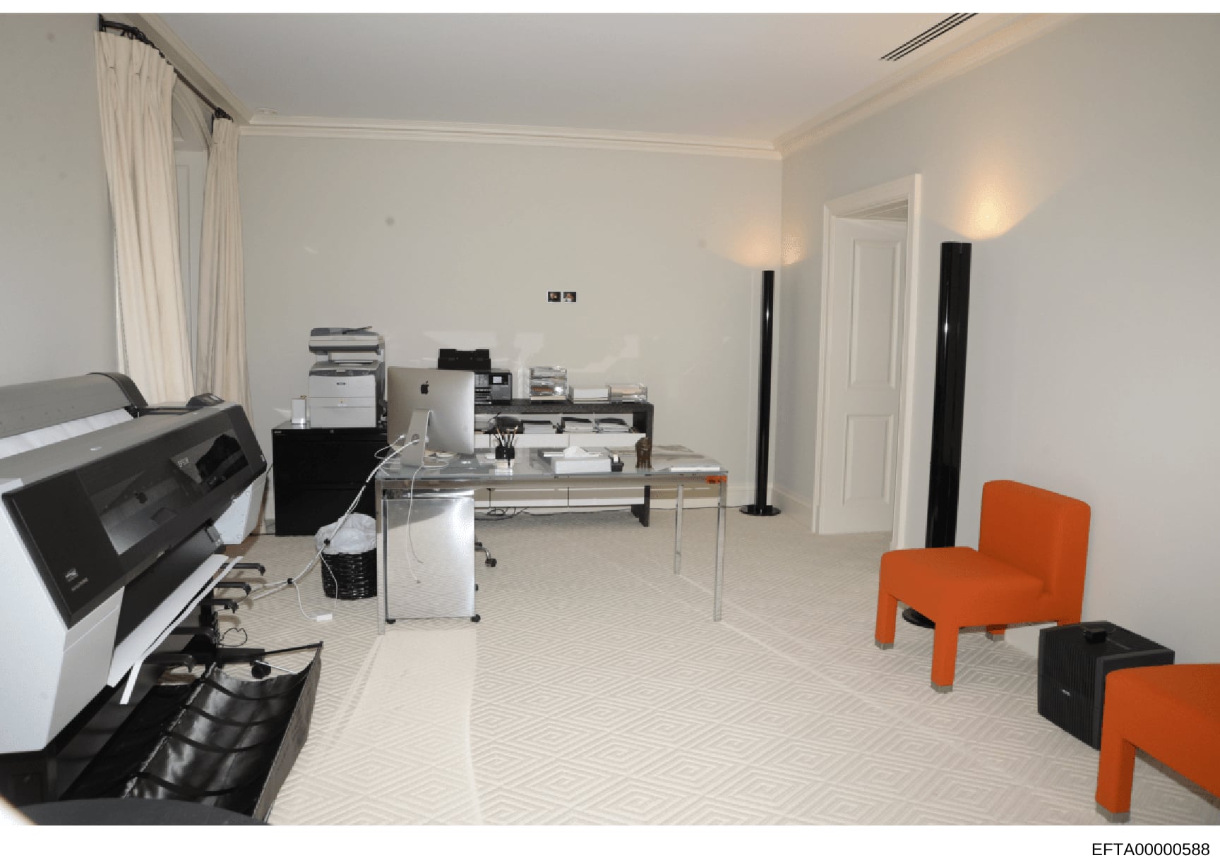 This is a photograph of a modern office space, likely part of an Epstein property, showing a well-furnished workspace with contemporary furniture, office equipment including printers and multifunction devices, and distinctive orange accent chairs. Th
