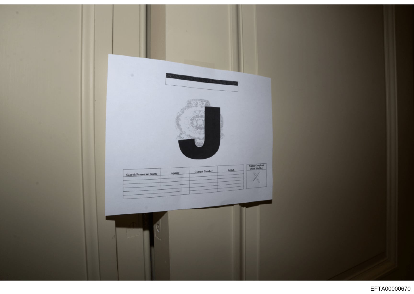 This is a photograph of an evidence or file cover sheet used in the investigation, displaying a large letter 'J' (likely indicating a file category or section marker). The document contains a table with columns for Search Personnel Name, Agency, Cont