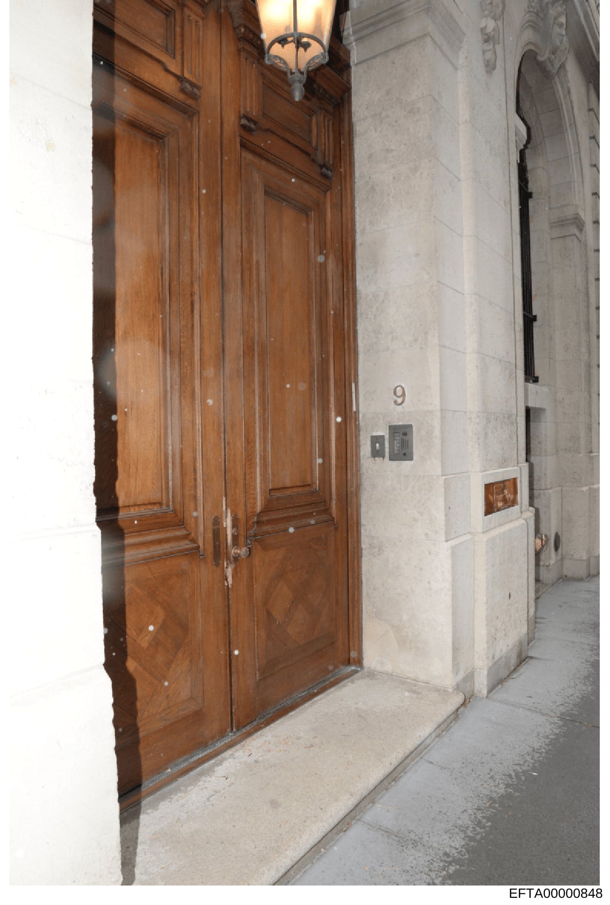 This is a photograph of the exterior entrance to a building located at 9 East 71st Street in New York City, showing a wooden double door entrance marked with the number 9. The image appears to be part of the investigative documentation of properties