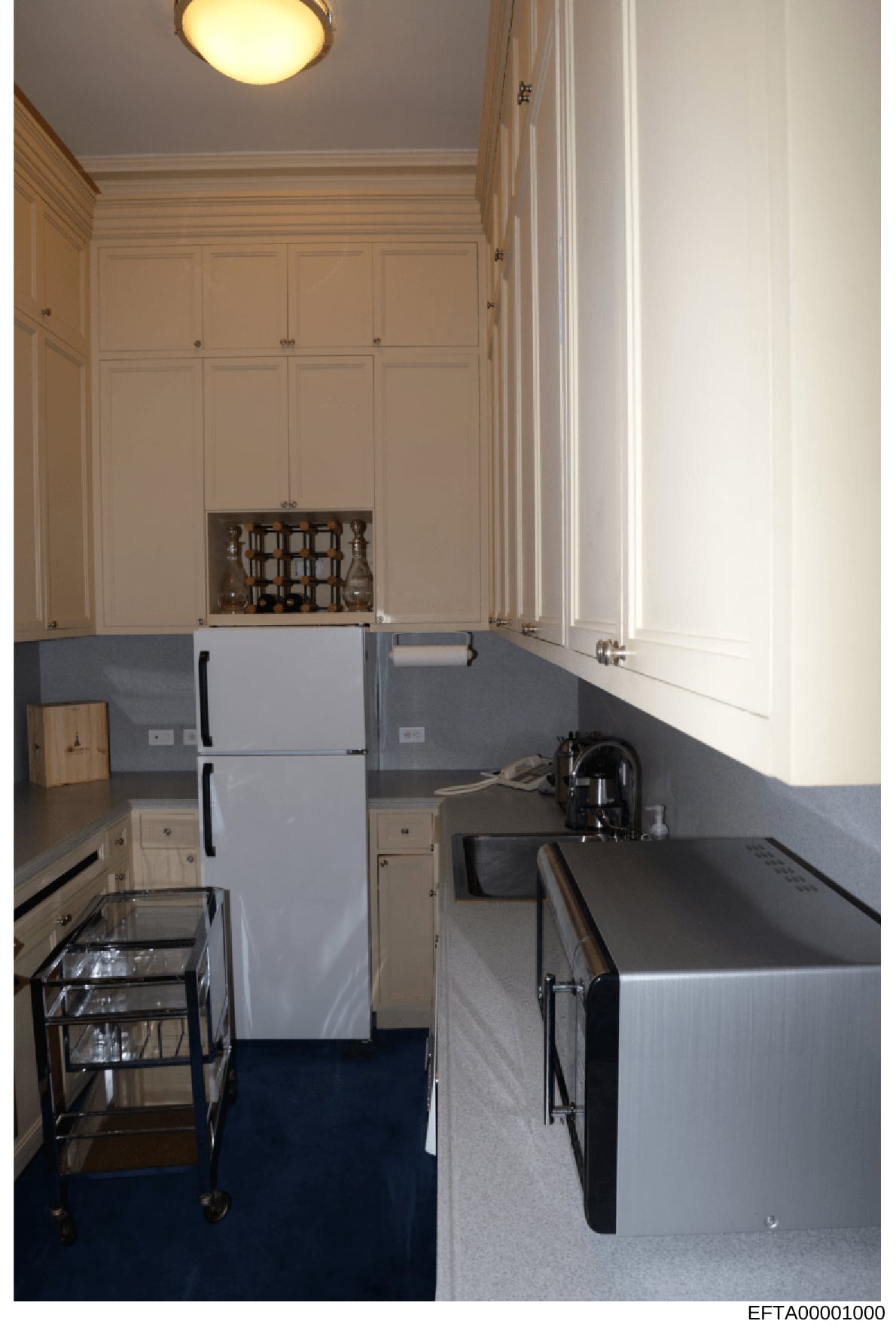 This is a photograph of a kitchen interior showing appliances, cabinetry, and finishes. The image appears to be documentation of a residential property, likely taken as part of the investigation's evidence collection regarding Epstein's properties an