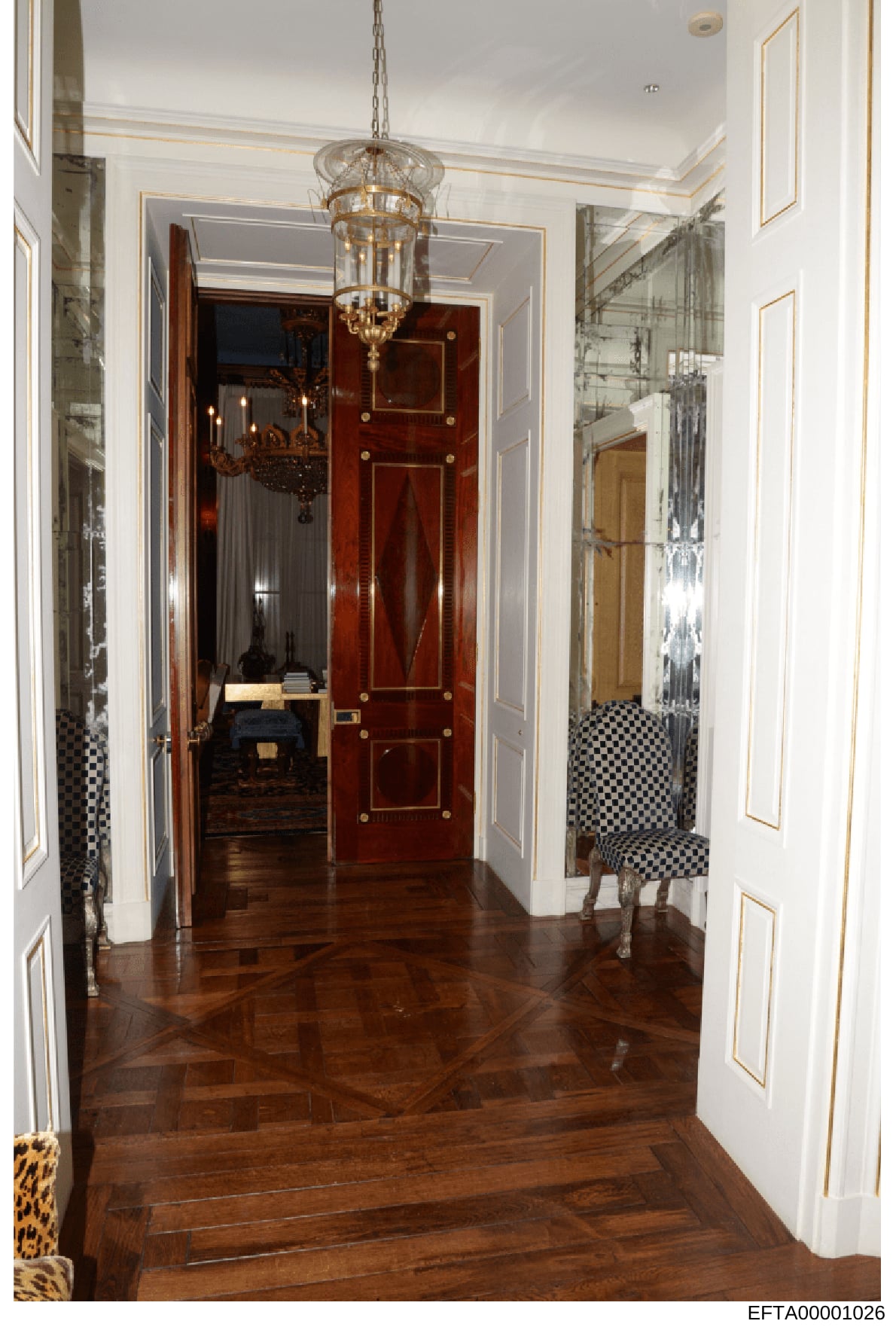 This is an evidence photograph documenting the interior of a luxurious residential hallway, likely from one of Jeffrey Epstein's properties. The image shows high-end architectural details including a grand entrance hallway with a decorative glass and
