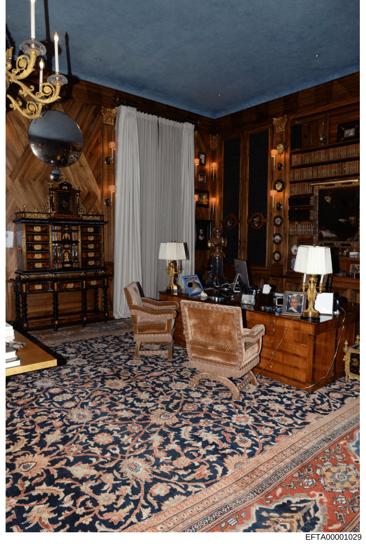 This photograph documents a lavishly decorated interior room featuring dark wood paneling, ornate furniture, and high-end décor. The room includes an ornamental desk, decorative cabinets, period furniture, gilt-trimmed lamps, and elaborate architectu