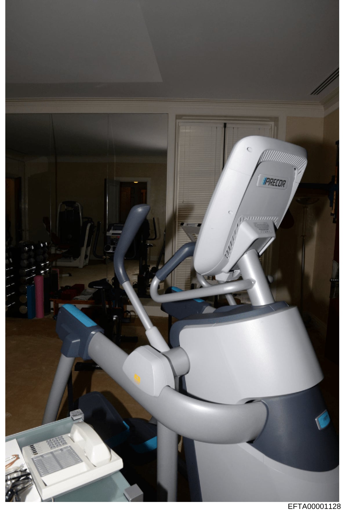 This photograph shows a Precor brand exercise machine (appears to be an elliptical or similar cardio equipment) located in a residential home gym or fitness space. The image documents the interior of what appears to be a luxury residential property's