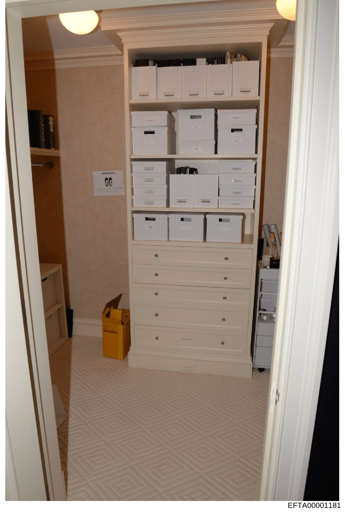 This is an evidence photograph showing the interior of a closet containing multiple white storage boxes organized on shelves, several drawers at the base, and filing materials. The image appears to be part of a property search or inventory, with a ye