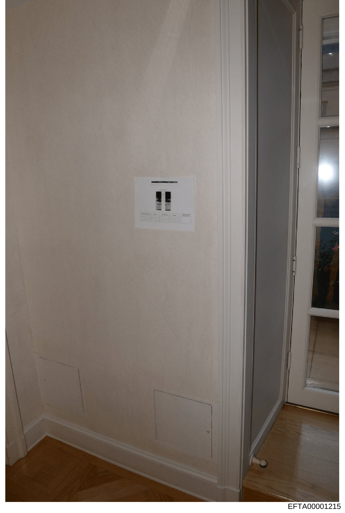 This is a photograph of an interior wall featuring a newly installed dual electrical outlet plate mounted on a white/cream colored wall. The image appears to be documentation of property fixtures or interior elements, possibly from one of Jeffrey Eps