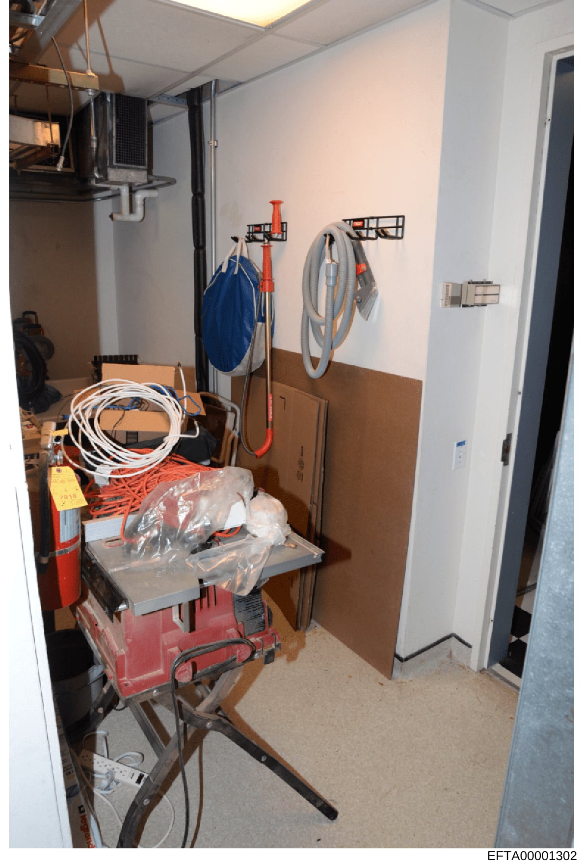 This photograph shows a storage or utility room, likely from one of Jeffrey Epstein's properties, containing various tools, cords, and equipment organized on walls and shelves. The image documents the contents and organization of this space as part o