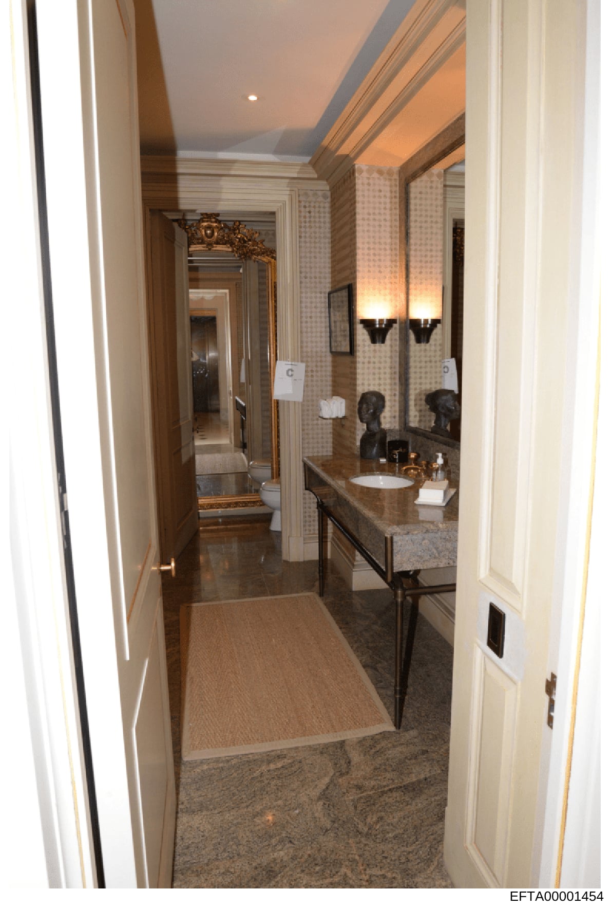 This photograph shows a high-end bathroom from what appears to be one of Jeffrey Epstein's properties. The image depicts an elegantly appointed master bathroom featuring a large double vanity with granite countertop, ornate mirror with gold frame, de