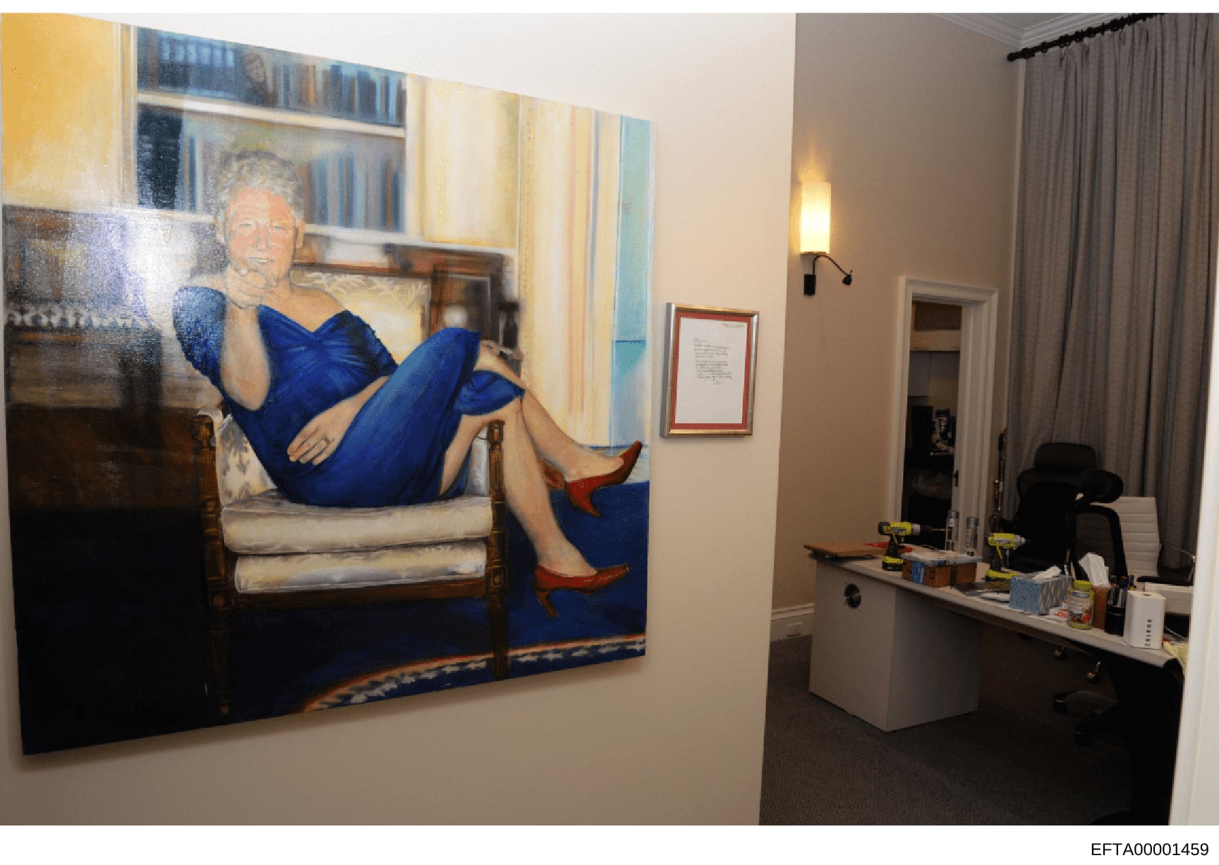 This photograph shows an interior office or residential space containing a large portrait painting of a woman in a blue dress seated on a chair. The space includes modern furnishings, shelving, desk areas, and curtained windows. The image was likely 