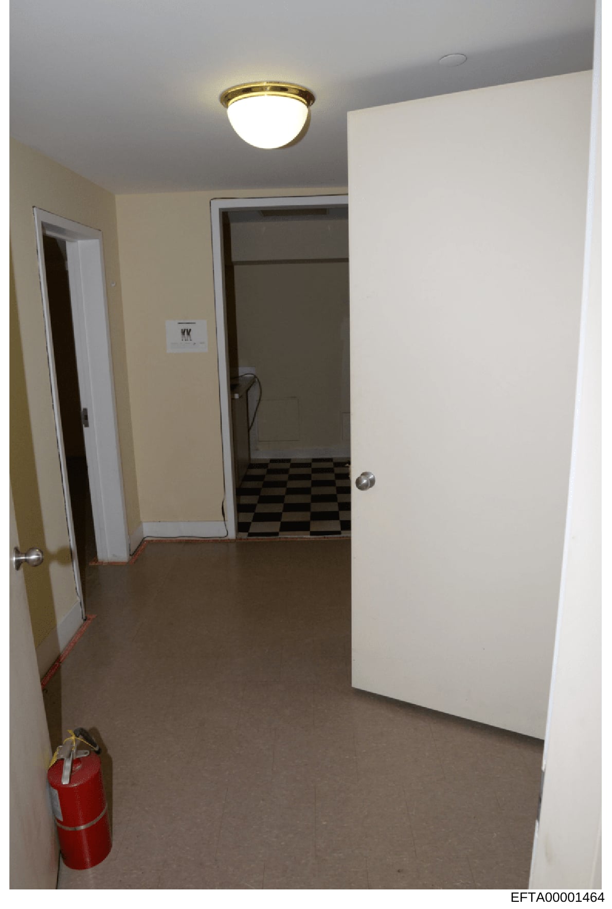 This is a photograph of an interior hallway or corridor space, showing basic architectural features including doorways, flooring, and ceiling fixtures. The image appears to be evidence documentation of a property, possibly related to the investigatio