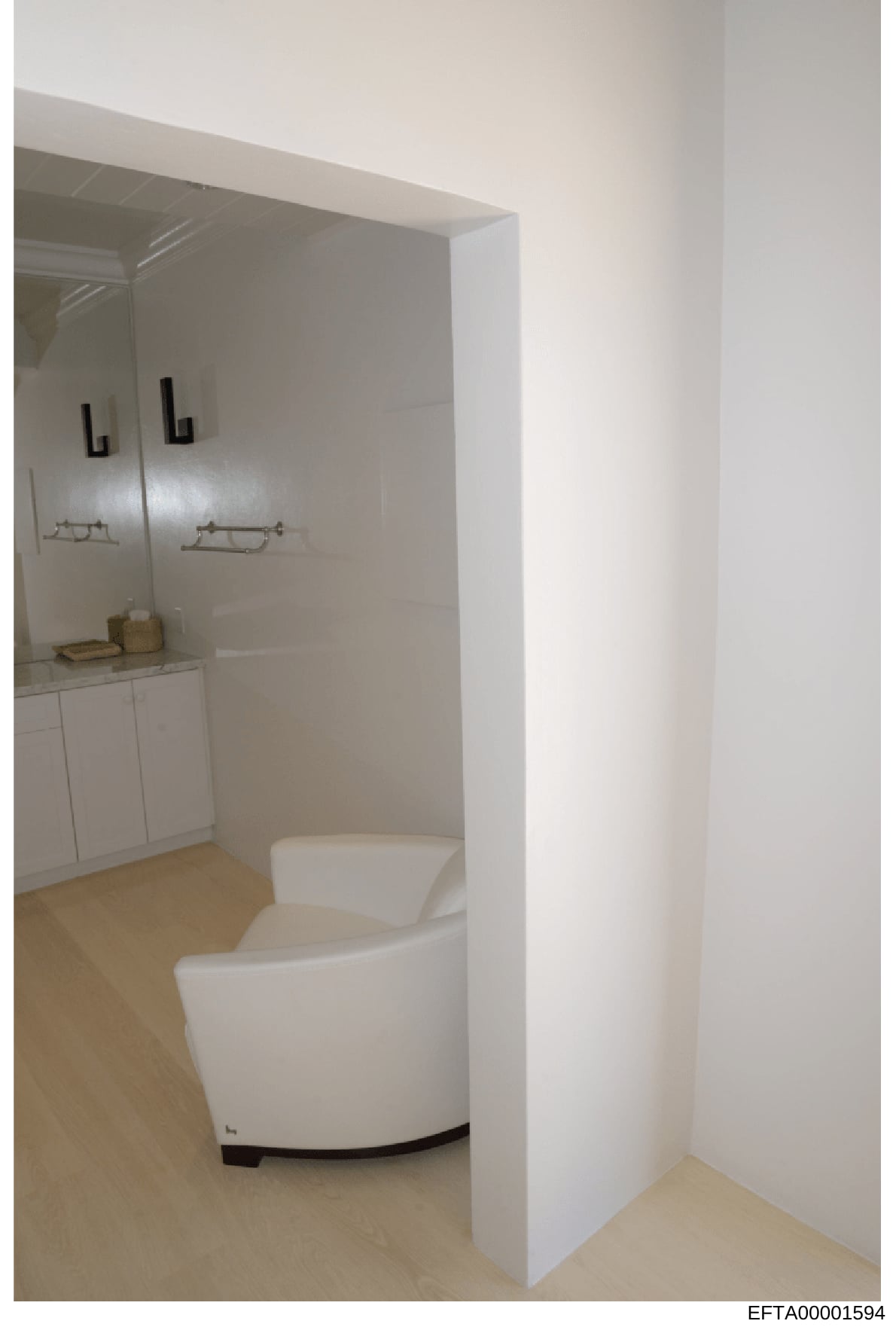 This is a photograph of a modern bathroom interior featuring a contemporary white toilet, vanity with mirror and lighting fixtures, and a shower enclosure. The image appears to be documentation of a property interior, likely taken as part of an evide