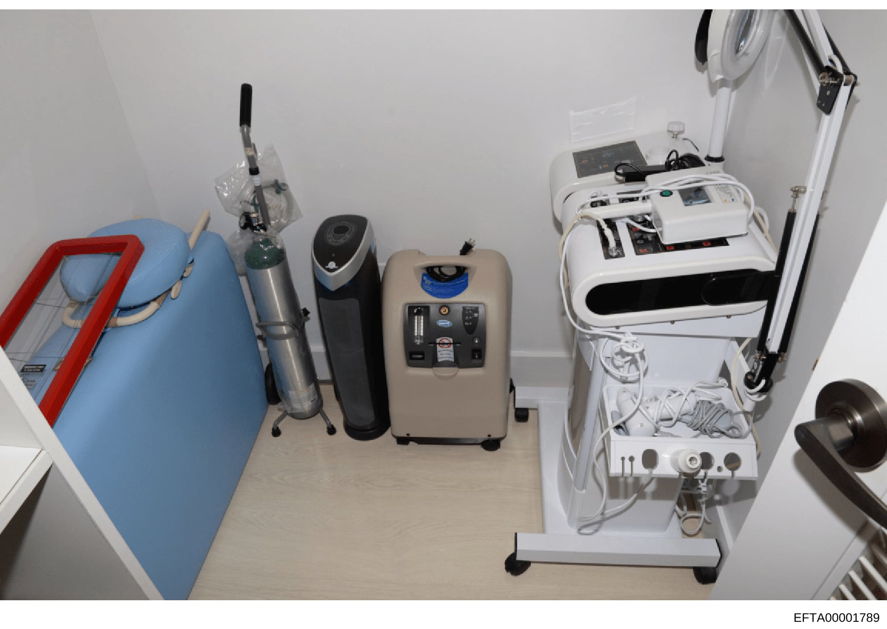 This photograph shows an overhead view of a room containing various medical or cosmetic treatment equipment, including what appears to be oxygen concentrators, a humidifier, and specialized treatment machines. The image documents the contents and lay