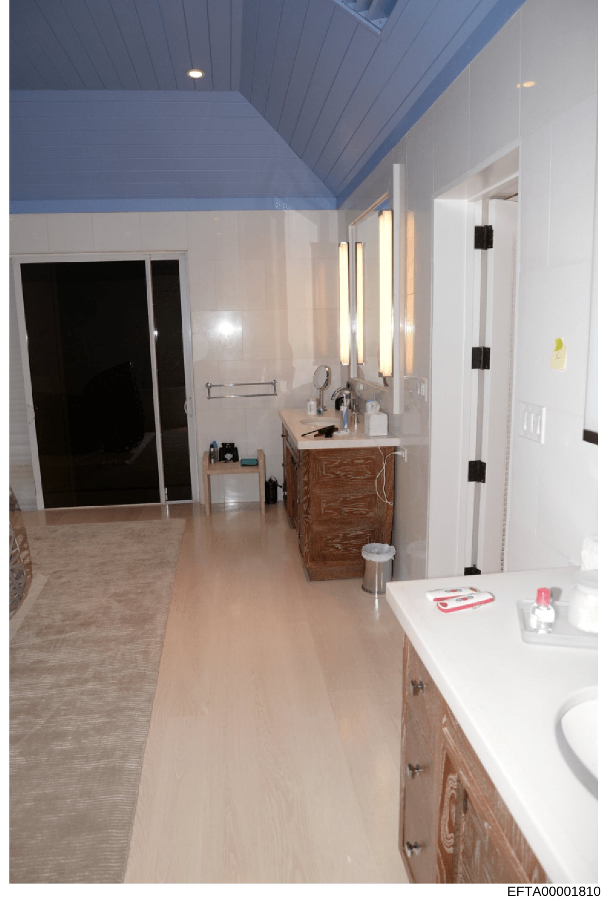 This is a photograph of a modern bathroom interior featuring dual vanities, a large walk-in shower with glass enclosure, and contemporary finishes. The image appears to be documentation of property interior spaces, likely taken as part of asset inven