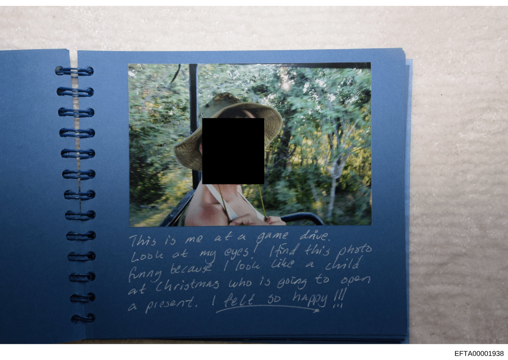 This is a page from a personal photo album containing a photograph with the subject's face redacted. The accompanying handwritten note describes the photo as being taken at a game drive, with commentary about the subject's appearance and a reference 