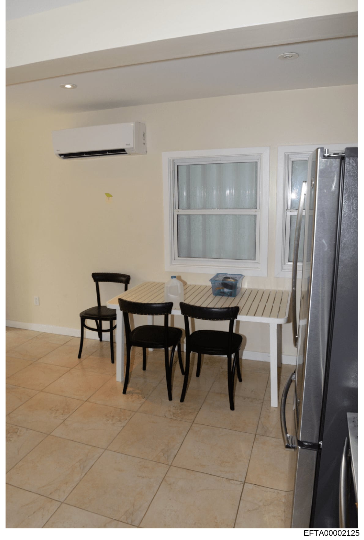 This is an evidence photograph showing the interior of a residential kitchen and dining space, featuring modern appliances, furnishings, and décor. The image appears to be part of property documentation or evidence collection related to an Epstein-as