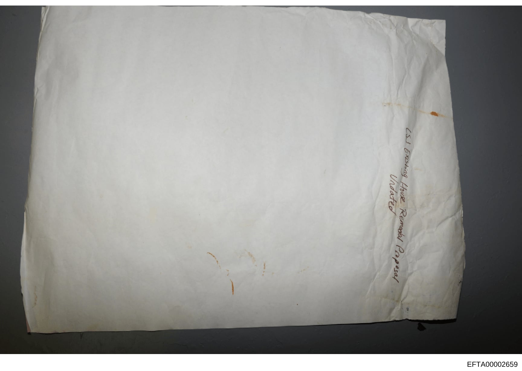 This is a photograph of a white envelope or package with handwritten text on its side. The visible handwriting appears to read 'Anne Russell, imported Packing' or similar text, though the exact wording is difficult to discern due to the angle and ima