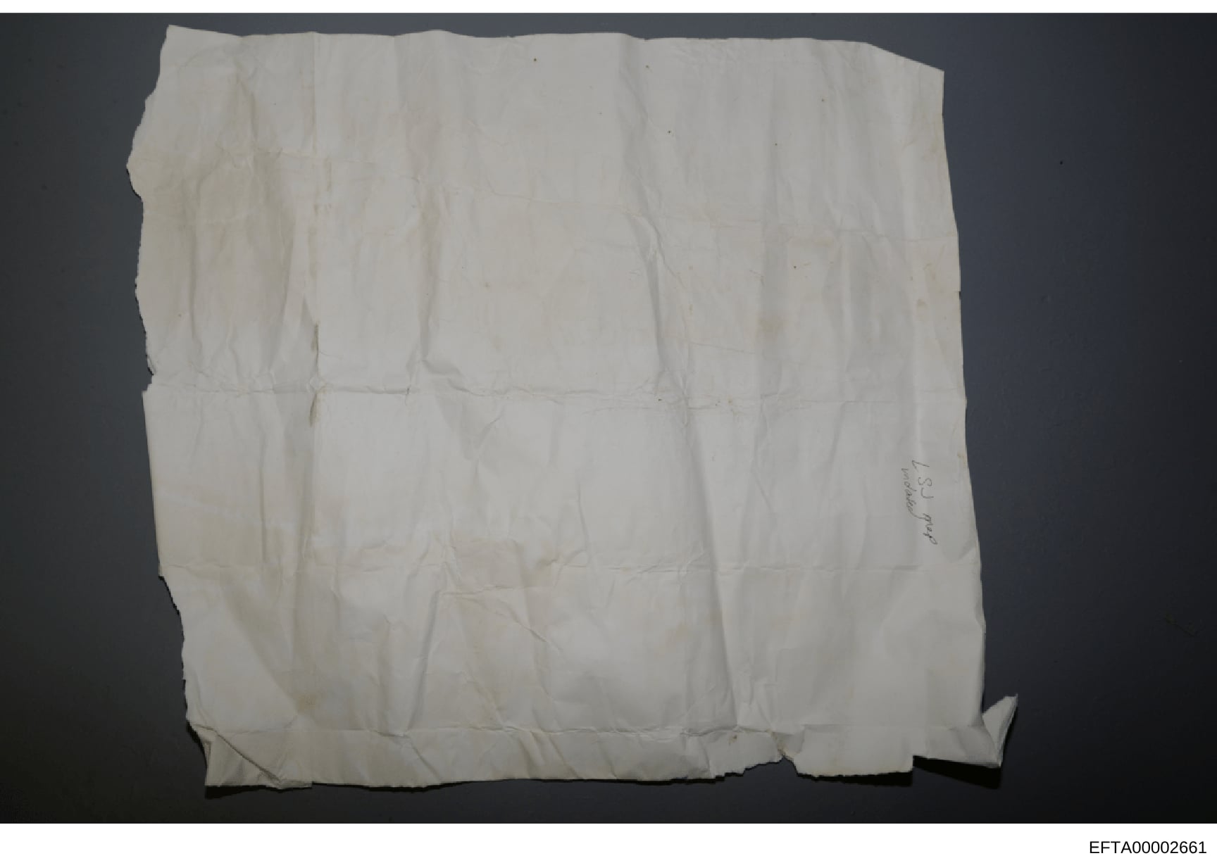 This is a photograph of what appears to be a blank, heavily creased, or deteriorated white cloth or paper document. The item shows significant wear with multiple fold marks and discoloration, suggesting it may be aged evidence material. The document'