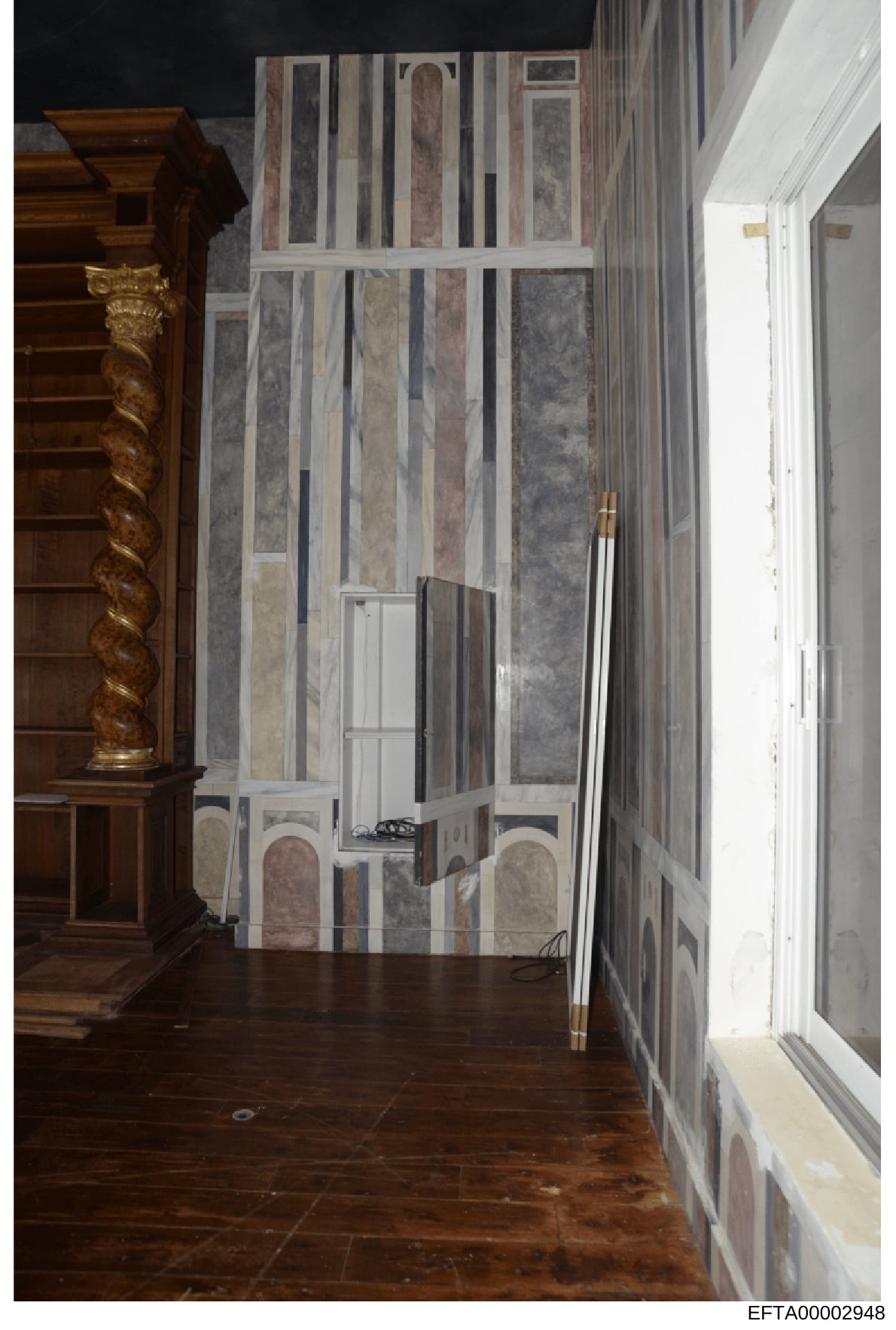 This is an evidence photograph showing an interior room with luxury finishes, including ornate wooden architectural elements with gold leaf detailing on the left, a striking marble-paneled wall with vertical striping in gray and burgundy tones in the