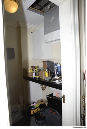 This is an evidence photograph showing the interior of a small utility or storage room, featuring white cabinetry, a black countertop, and various tools and equipment stored throughout. The image appears to be part of property documentation in the Ep