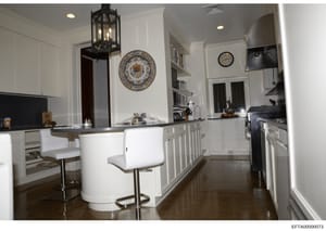 This is a photograph of a high-end residential kitchen featuring white cabinetry, modern appliances, and decorative elements. The image appears to be documentation of interior spaces within one of Jeffrey Epstein's properties, likely taken during a p