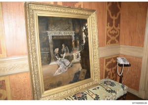 This is a photograph of an interior room, likely from one of Jeffrey Epstein's properties, showing an ornately framed classical painting depicting a historical or mythological scene. The room features period wallpaper with damask patterns, decorative