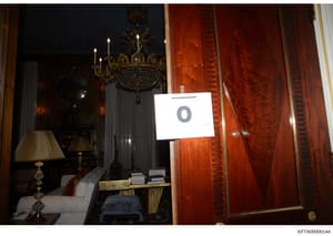 This is an evidence photograph from the Epstein investigation showing an ornate interior room, likely from one of Epstein's residences. The photo includes an evidence marker labeled '9' and captures luxury furnishings including a crystal chandelier, 