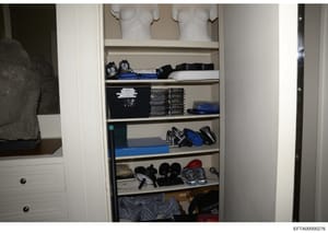 This is an evidence photograph showing the interior of a built-in closet containing various sports equipment, athletic shoes, clothing, and personal belongings. The image documents the contents and organization of what appears to be a residential clo