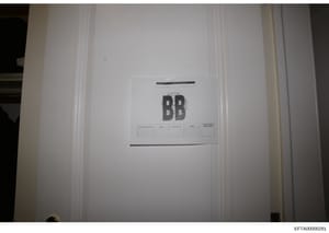 This is a photograph of a document cover page or divider marked with large 'BB' letters and a Bates stamp identifier. The page appears to be part of an organized document collection in the Epstein investigation files, with filing reference fields vis