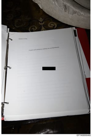 This is a photograph of a page from what appears to be a binder or ring-bound document. The visible text reads 'Intensive writing' as a header and 'A grade can be defined as marking your accomplishments' as body text. A substantial portion of content