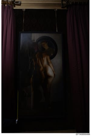 This is a photograph of a framed artwork displayed in an interior space with purple curtains. The painting depicts a figure wearing a wide-brimmed hat in a classical artistic style. The photograph appears to be evidence documentation from a property 