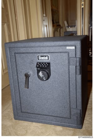 This is a photograph of a Gardall brand security safe discovered during the investigation of Jeffrey Epstein's property. The safe features a combination lock and manual key lock, indicating it was used to store valuables or documents. The image shows
