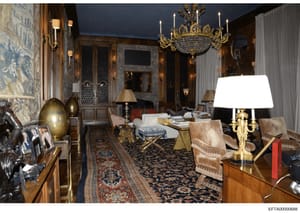 This photograph documents a luxuriously appointed formal reception or living room within Jeffrey Epstein's Manhattan residence. The image shows an ornate interior with high-end furnishings, including a crystal chandelier, gilt-edged mirrors, decorati