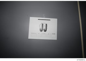 This is an evidence photograph showing a document marked with large 'JJ' initials at the center. The document contains a table with columns for 'Search Personnel Name,' 'Agency,' 'Contact Number,' 'Initials,' and 'Search Completed (Date & Time).' The