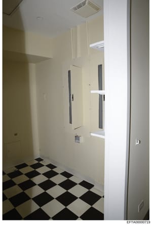 This is an evidence photograph of a bathroom interior, likely from one of Jeffrey Epstein's properties. The image shows a cream-colored bathroom with a distinctive black and white diamond-pattern tile floor, multiple vanity mirrors with dark frames, 