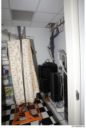 This is an evidence photograph showing an interior utility or storage room, likely from one of Jeffrey Epstein's properties. The image depicts a small enclosed space with a drop ceiling, black and white checkered flooring, and various household items
