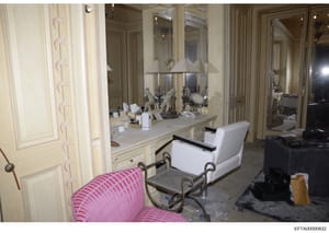 This is a photograph of an upscale bathroom interior, likely from one of Jeffrey Epstein's properties. The image shows a spacious bathroom with dual vanities, large mirrors, decorative lighting, marble countertops, and ornate furnishings including a 