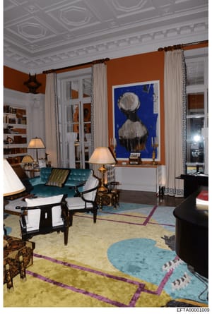 This is a high-resolution photograph of an elegantly decorated living room featuring custom furnishings, artwork, and architectural details. The room displays sophisticated interior design with contemporary and classical elements, including a promine