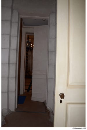 This is a photograph of an interior hallway in what appears to be a residential property, showing doorways, white paneled walls, and architectural details. The image documents the interior layout and construction of a property that is part of the Eps