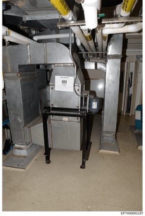 This is an evidence photograph showing HVAC (heating, ventilation, air conditioning) equipment and ductwork in what appears to be a basement or mechanical room. The image documents the property's mechanical systems, including furnace units, piping, a