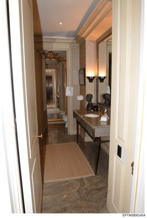 This photograph shows a high-end bathroom from what appears to be one of Jeffrey Epstein's properties. The image depicts an elegantly appointed master bathroom featuring a large double vanity with granite countertop, ornate mirror with gold frame, de
