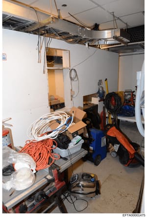 This is a photograph of a utility room or storage area, possibly within one of Epstein's properties. The room contains various maintenance and construction tools and equipment, including coiled electrical cords (both white and orange), a blue utility