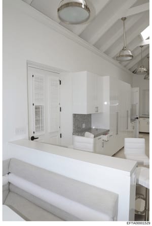 This is a photograph of a luxury bathroom interior featuring modern white cabinetry, a large walk-in shower with glass enclosure, and contemporary lighting fixtures. The image appears to be documentation of property interior design, likely from one o