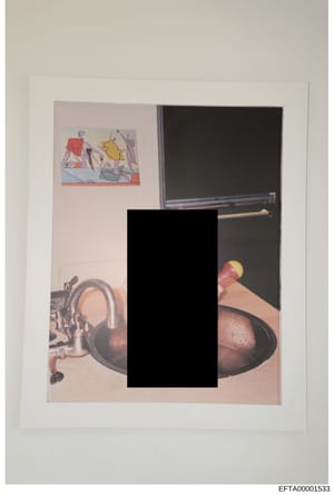 This is an evidence photograph showing the interior of a room with various items visible including artwork on the wall, electronic equipment, and other objects. A large central portion of the image has been redacted with a black rectangle, obscuring 