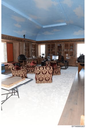 This is an evidence photograph of an upscale interior room featuring extensive built-in wooden cabinetry, bookshelves, ornate furniture, and modern office equipment. The space appears to be part of a high-end residential or office property, documenti