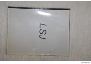 This is a photograph of a clear plastic evidence bag or document sleeve containing a white card or label marked with 'EFTA' handwritten in dark ink. The bag appears to be a standard evidence storage container used in law enforcement investigations, w