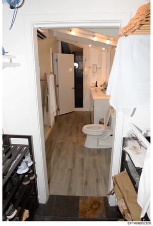 This is a photograph of a residential bathroom interior, showing fixtures, layout, and conditions. The image appears to be documentation photography, possibly for property inventory, maintenance records, or investigative purposes related to a residen